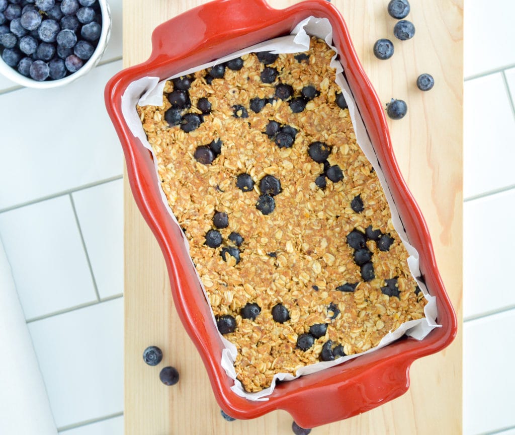 These No-Bake Blueberry Granola bars feature fresh blueberries and have very little added sugar. With just a few simple ingredients and no oven required, there are the perfect nutritious snack to whip up in the heat of the summer or anytime throughout the year! #nobake #granolabars #blueberrybars #healthysnack #healthygranolabar