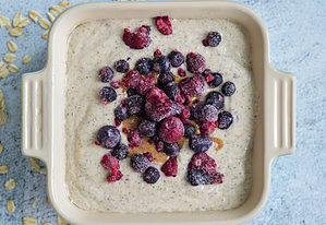 vegan baked oatmeal batter with berries on top
