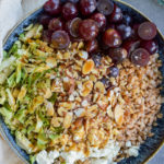 farro salad with feta, sliced almonds, red grapes and sliced brussels sprouts, topped with maple vinaigrette