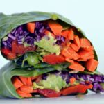 vegan collard green wrap filled with colorful vegetables